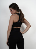 Open back extended vest tank top in black - back view